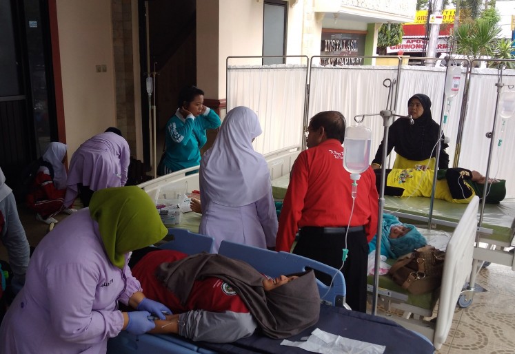 Intensive care: Medical workers check tend to teachers struck by food poisoning in a hospital in Wonogiri, Central Java, on Tuesday.