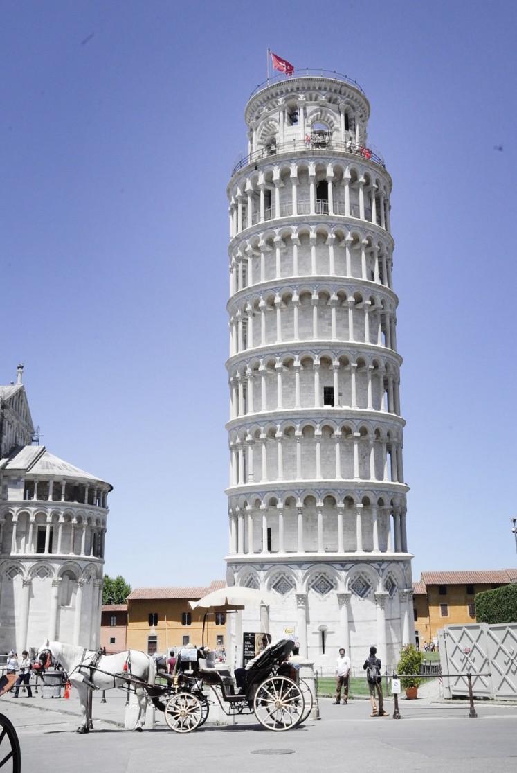 Iconic building: A horse-drawn carriage awaits passengers in front of the Leaning Tower of Pisa.