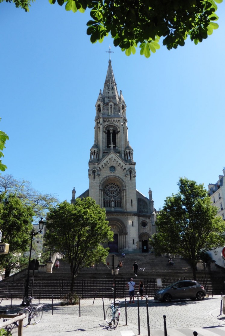 The Church of Our Lady of the Cross of Menilmontant looks down on the small square.