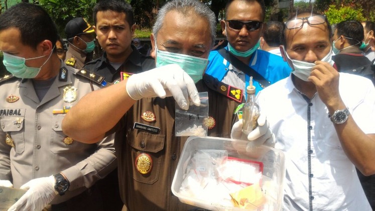 Off the streets: Bogor Regency Prosecutor's Office head Bambang Hartarto (center) shows baggies of crystal methamphetamine and other drugs that were confiscated during recent operations.