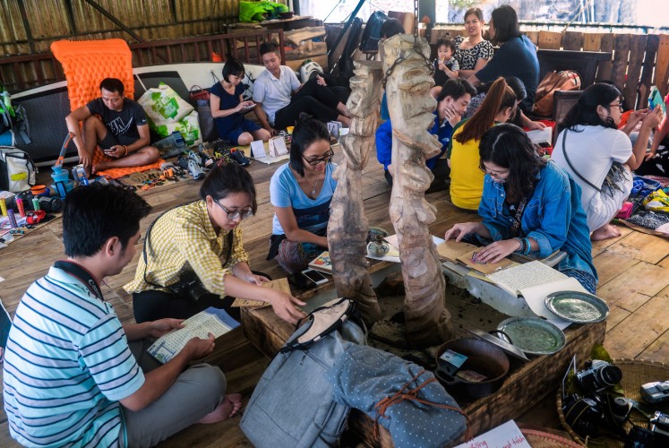 In this photograph taken on October 29, 2017, people visiting a once-a-month ex lover's market in Hanoi look for items only on display and which belong to the owner of the market. Shuffling through Vietnam's 