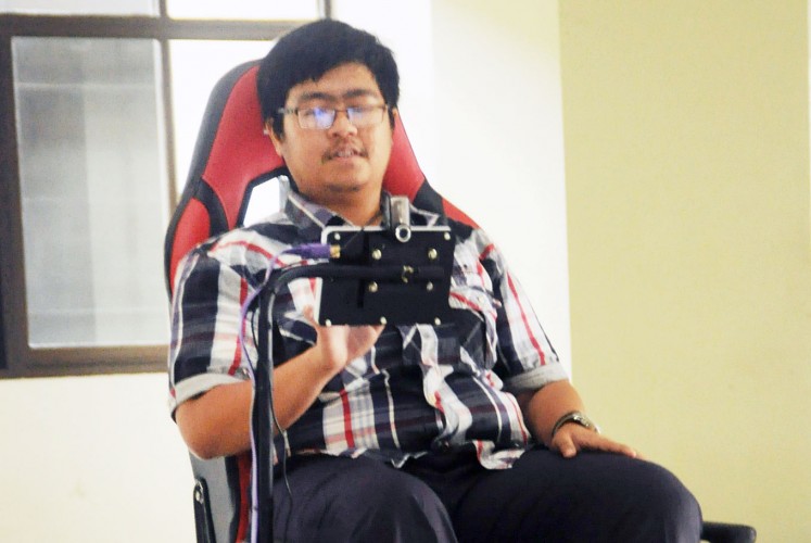 On the move: Fakih, a disabled student of Brawijaya University in Malang, East Java, tries out a smart wheelchair developed at the university.