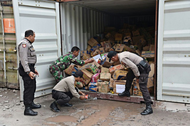 In crisis: Police and military personnel unload on Sunday food packages that will be delivered to residents in Banti and Kimbely villages in Tembagapura, Mimika, Papua, who have been taken hostage by Free Papua Movement (OPM) members. 