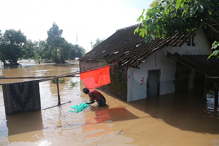 In crisis: Floodwater inundates the house of a local resident living on the riverbank in Kampung Semanggi, Surakarta, Central Java. 