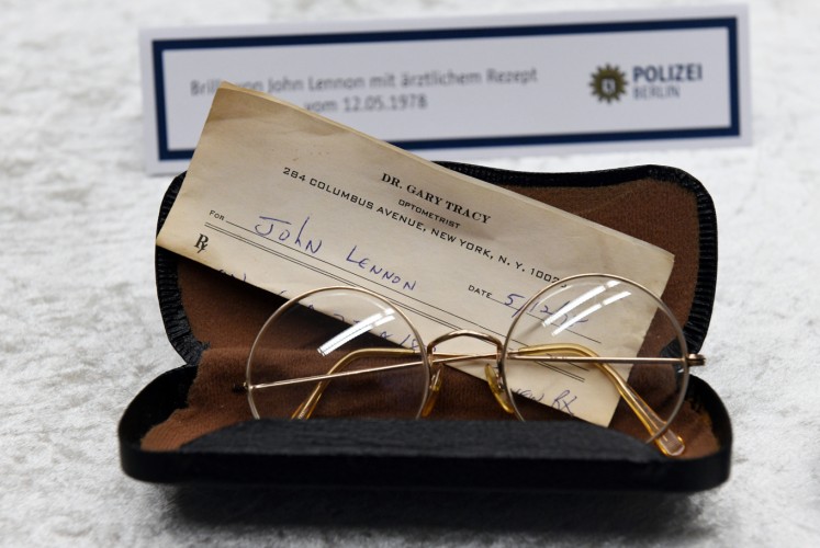 Glasses from the estate of John Lennon are pictured during a press conference on November 21, 2017 in Berlin. German police on November 20, 2017 had arrested a 58-year-old man in Berlin on suspicion of handling the stolen items, including the late Beatle's diaries. The items were stolen from Lennon's widow Yoko Ono in New York in 2006.