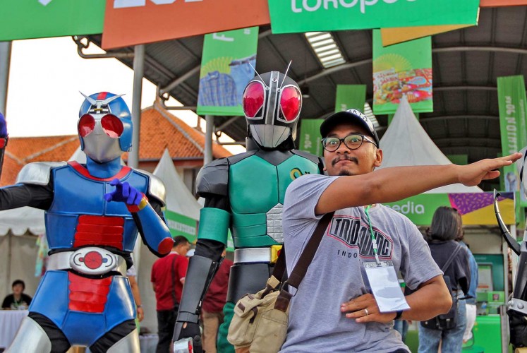 Blast from the past: A visitor poses with characters from the 1990s TV show Ksatria Baja Hitam (Masked Rider Black) during The 90s Festival at JIExpo in Jakarta on Saturday. Currently in its third year, the event celebrates music, games and food popular in the 1990s.