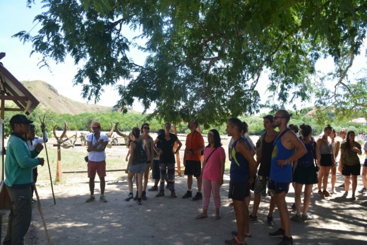Safety first: A ranger (left) gives safety instructions to tourists visiting Rinca Island in West Manggarai regency, East Nusa Tenggara. 