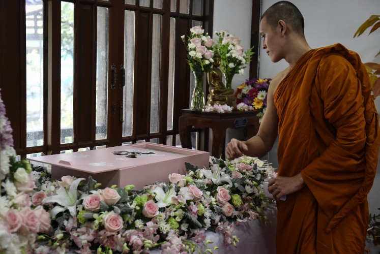 This photo taken on September 14, 2017 shows a Buddhist monk blessing the body of Dollar, a six-year-old Shih Tzu dog, during the pet's funeral at Wat Krathum Suea Pla Buddhist temple in Bangkok. Pet cremations, complete with Buddhist rituals, are popping up across Bangkok for dogs, cats and even monkeys. In a devout Buddhist kingdom where religion and superstitious beliefs entwine, some pet owners believe the monk-led send off will boost their pets' chances of being reincarnated as a higher being.

