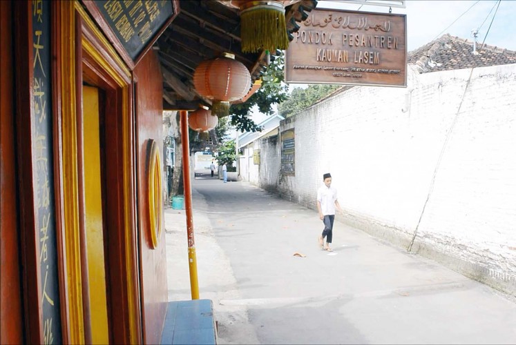 Best of both worlds: A student enters the gate of the Kauman Islamic Boarding School which features Chinese traditional lanterns.