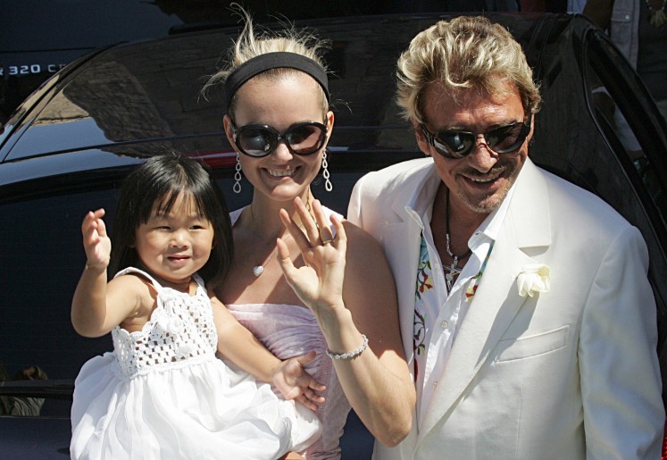 This file photo taken on July 29, 2006 shows French singer and actor Johnny Hallyday, his wife Laeticia and their daughter Jade, arriving to the Baux-de-Provence's townhall, southern France, to attend the wedding ceremony of French actor Jean Reno, 58, with French-American top-model and comedian Zofia Borucka, 35. 