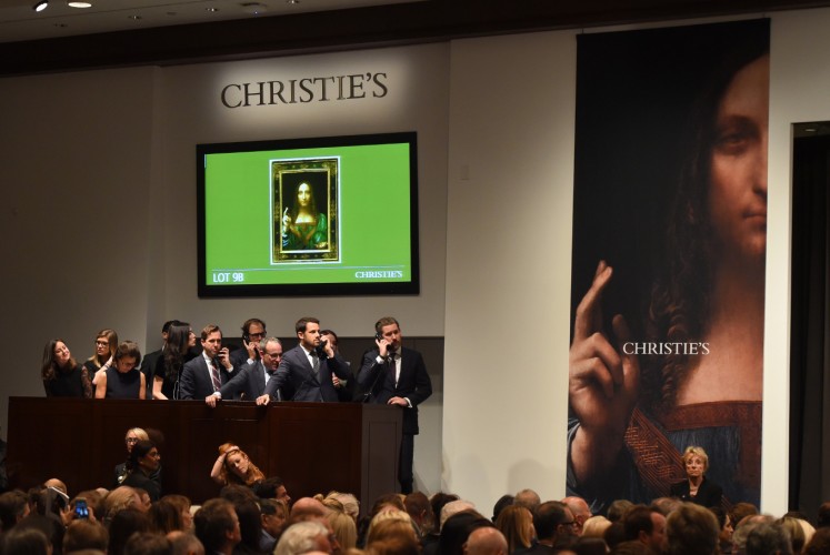 Christie's employees take bids for Leonardo da Vinci’s 'Salvator Mundi' at Christie's New York November 15, 2017. A 500-year-old work of art depicting Jesus Christ, believed to be the work of Renaissance master Leonardo da Vinci, sold in New York on Wednesday for $450.3 million setting a new art auction record, Christie's said. 