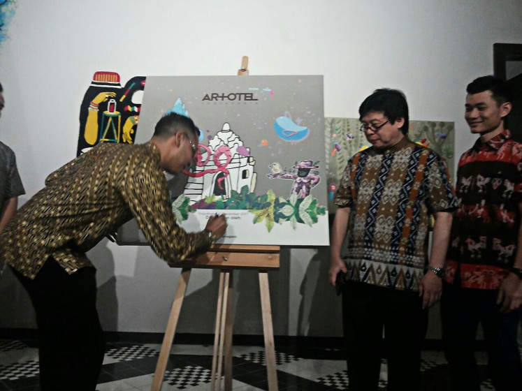 Showing support: Kanjeng Pangeran Haryo (KPH) Wironegoro of the Yogyakarta Palace signs a canvas to mark the official opening of Artotel Yogyakarta Hotel on Jl. Kaliurang KM 5.5, Sleman regency, on Thursday evening, while Handoko Wignjowargo and Kevin Rasanto of Rasanto Group, which owns the property, look on.