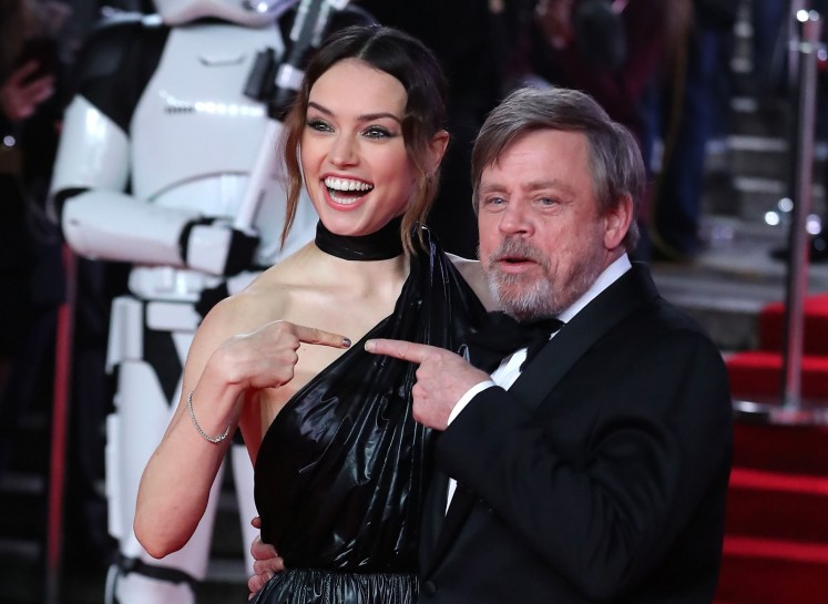English actress Daisy Ridley (L) and US actor Mark Hamil pose on the red carpet for the European Premiere of Star Wars: The Last Jedi at the Royal Albert Hall in London on December 12, 2017. 