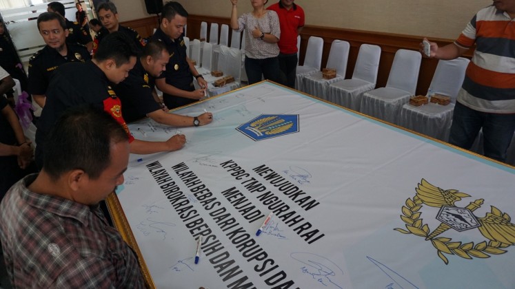 Showing commitment: Representatives of the Customs and Excise Officer at Ngurah Rai International Airport in Bali sign an integrity zone declaration on Wednesday.