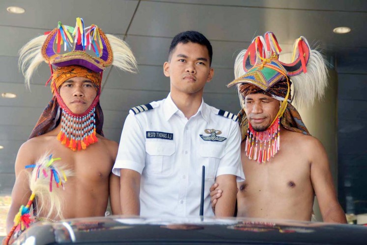 From zero to hero: At the age of just 17, Resto Thomas Aquino Jehabut (center) has been named the first pilot from West Manggarai, East Nusa Tenggara, during a ceremony in Manggarai.