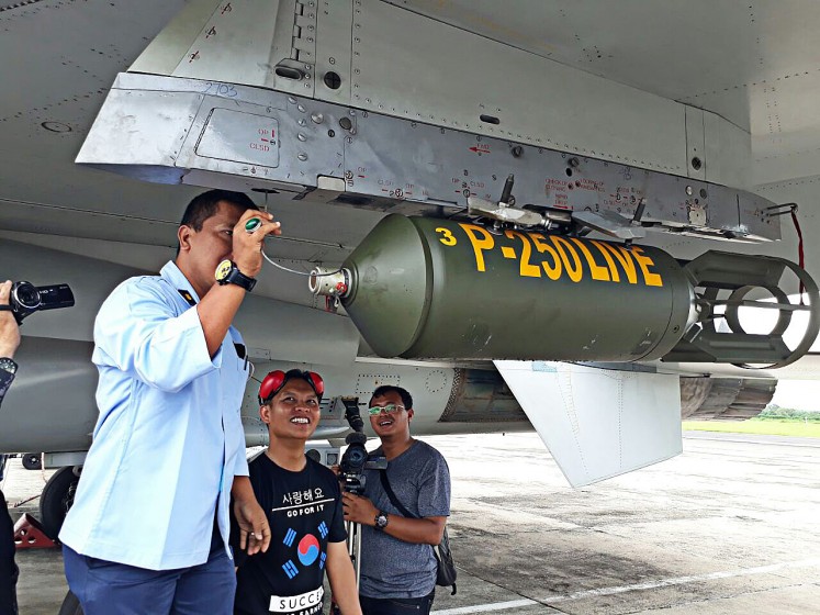 Getting prepared: A technician at Iswahjudi Air Force Base in Madiun, East Java, checks a P-250 Live bomb ahead of a bomb test at the Air Force Base on Dec.15. 