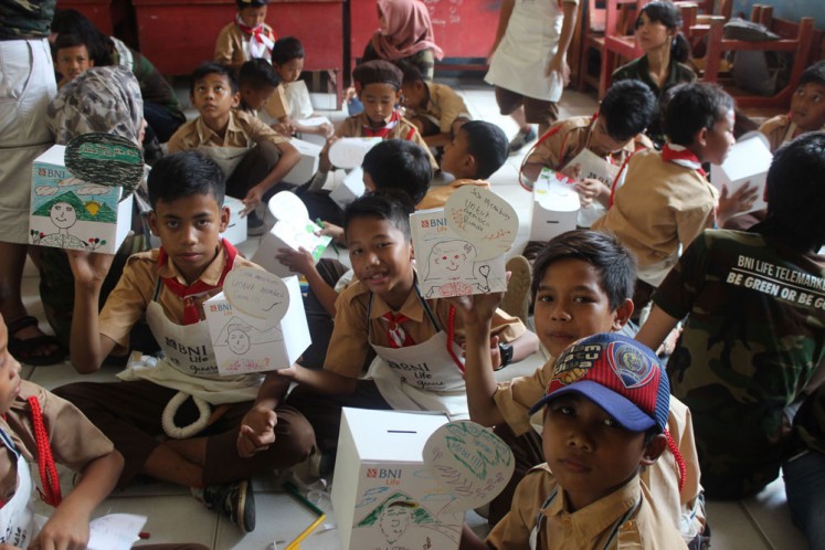 The beauty of saving: Elementary school students of Kosambi show saving boxes they have decorated in a course provided by BNI Life.