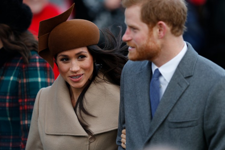 US actress and fiancee of Britain's Prince Harry Meghan Markle and Britain's Prince Harry arrive to attend the Royal Family's traditional Christmas Day church service at St Mary Magdalene Church in Sandringham, Norfolk, eastern England, on December 25, 2017. 