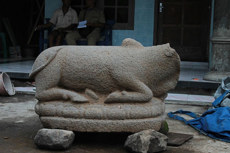 Ancient object: A headless cow statue is ready for inspection after being found by residents of Siwal village, Baki district, Sukoharjo regency, Central Java, on Jan. 8. The artifact is believed to be a relic of the Hindu Mataram era.
