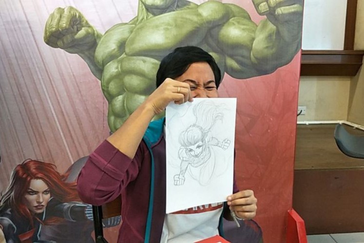 Miralti “Alti” Firmansyah with her sketch of the superhero version of Syahrini.