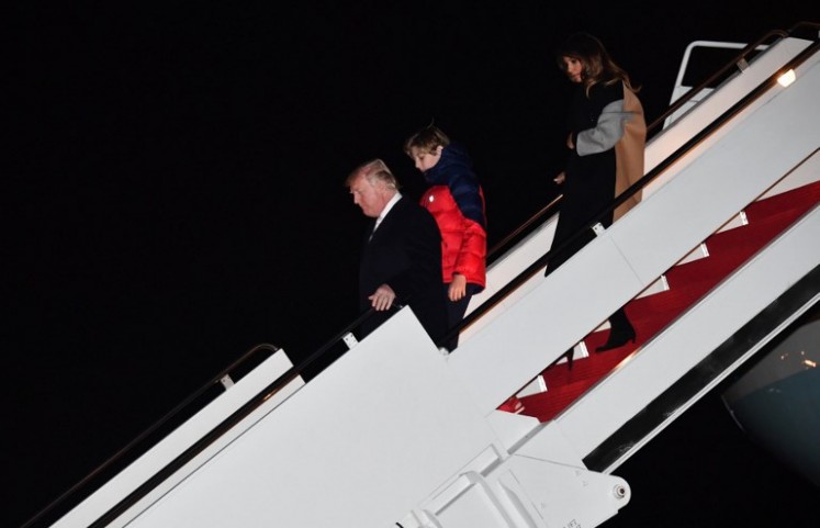 US President Donald Trump and First Lady Melania Trump, with their son, Barron, arrive at Joint Base Andrews in Maryland on Jan. 15, 2018.