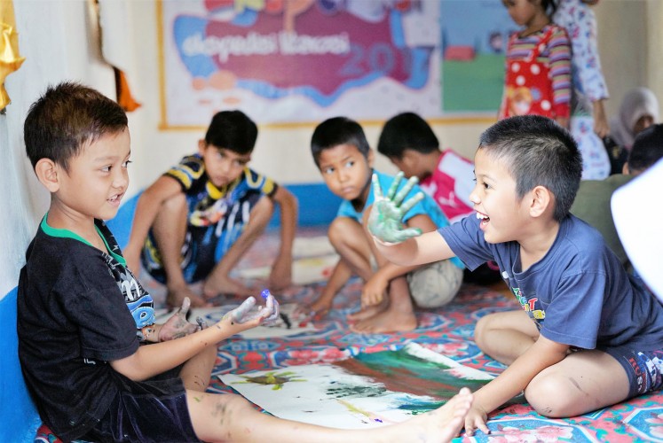 Little artists: Children from villages near Bukit Rimbang Bukit Baling Wildlife Sanctuary in Riau participate in an art activity.