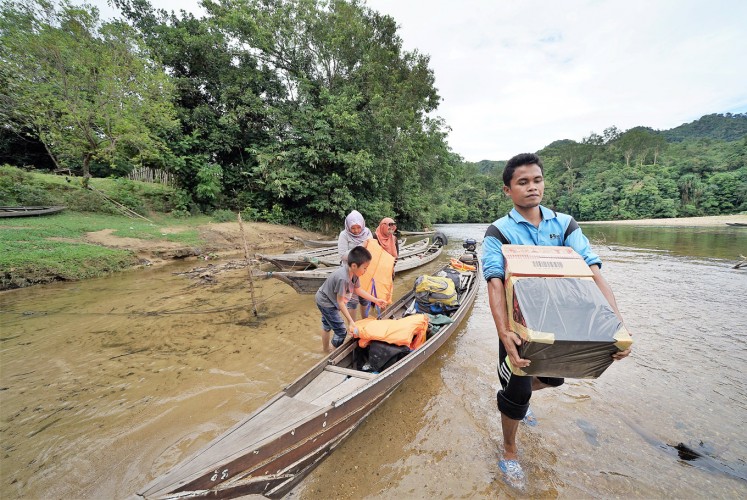 Transporting knowledge: In this remote area in Riau, books can only be distributed with small boats.