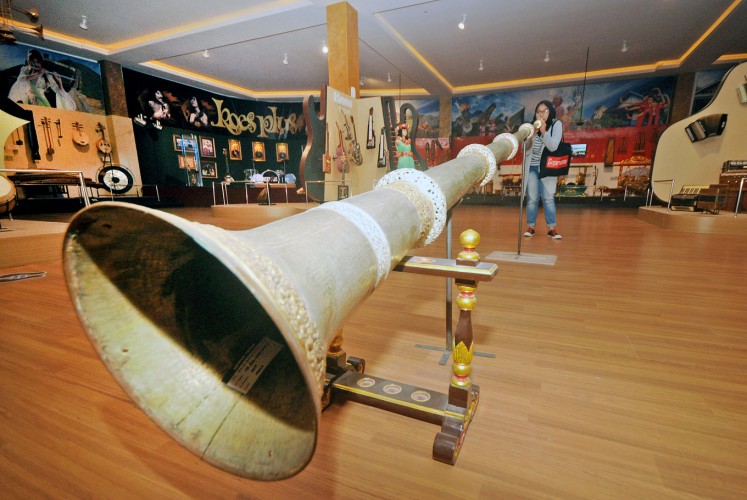 Give it a blow: A visitor attempts to blow a long traditional trumpet from Tibet.
