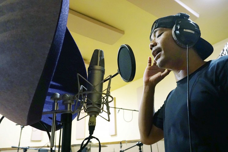 Pitch perfect: Antrabez vocalist Febri rehearses before a recording session at Antida Music Studio in Denpasar, Bali.