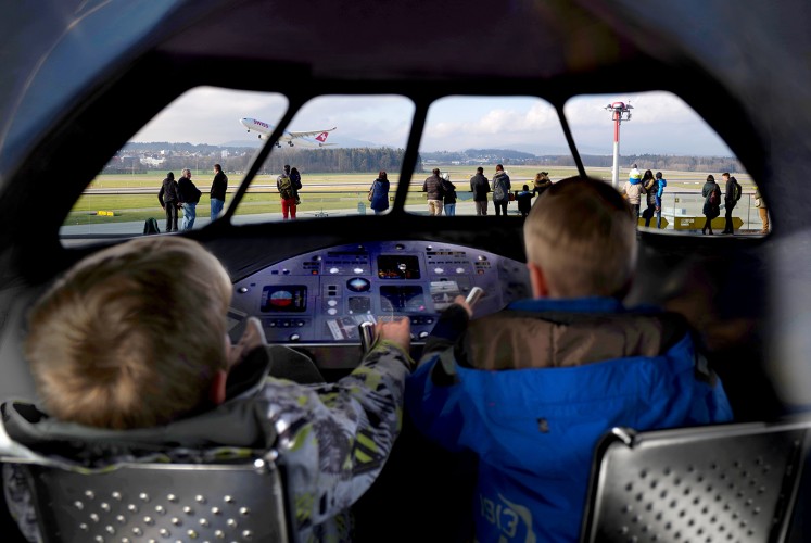 Children play at being pilots at Zurich International Airport