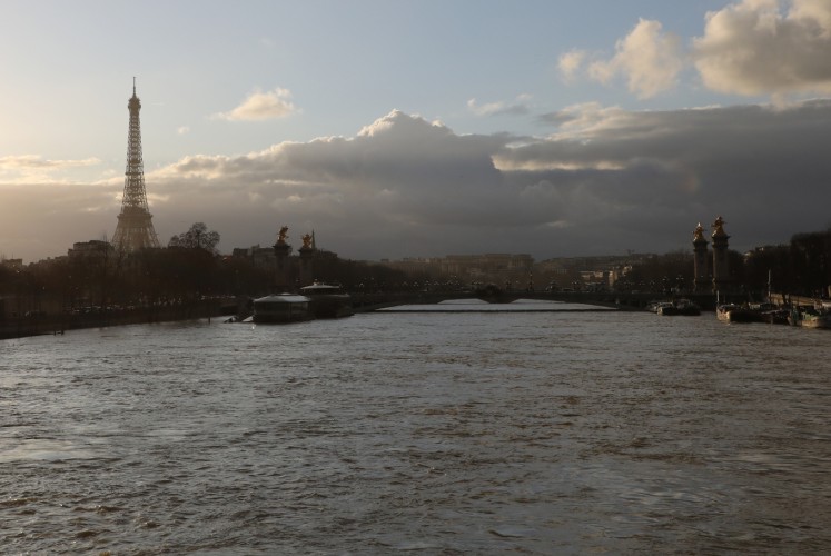 A picture taken on January 26, 2018, shows the flooded banks of the river Seine with the Eiffel Tower in the backround in Paris. Leaks were starting to appear on January 26 in the basements of Paris buildings as the Seine inched higher, with forecasters warning that the river could stay high throughout next week, especially if more rain is dumped on France. The Vigicrues flooding agency scaled back its peak predictions for the river in the capital, saying it will top out at 5.8 to 6 metres (19 to 19.7 feet) between Saturday afternoon and Sunday morning, compared with 6.2 metres previously.