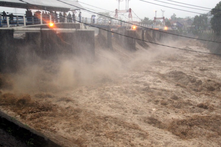A torrent of floodwater is seen at the Katulampa sluice gate in Bogor, West Java, on Monday.