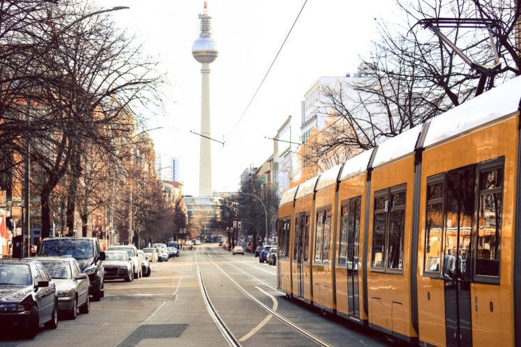 Yellow public transportation tram passing through the city of Berlin, Germany.