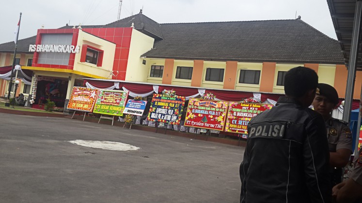 On alert: Several police officers are on guard in front of the Bhayangkara Police Hospital in Yogyakarta, where suspected church attacker Suliyono was treated for gunshot wounds. Suliyono was taken to Jakarta on Feb.13 for further questioning. 