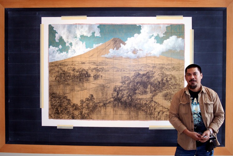 Shaping perceptions: Artist Jumaldi Alfi poses in front of his painting Melting Memories, Rereading Landscape, Mooi Indies #03 ( 2013 ) on Feb. 6.
