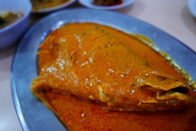 Fish head curry is the signature dish at Medan Baru restaurant. 