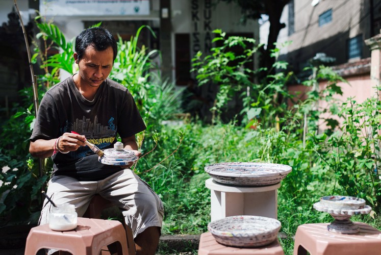 Upcycle: A Rumah Berdaya activist demonstrates how to make trays using recycled papers.