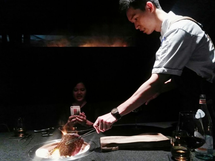 Executive sous chef Joel Lim grills a rib eye for 'The Post'.