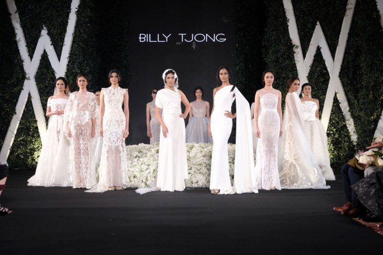Models pose in flowing dresses and gowns from Billy Tjong's 'Diving Beauty' collection.