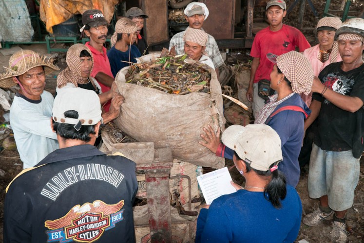 People collect trash at a local recycling facility in Pererenan which is owned and operated by the local community.