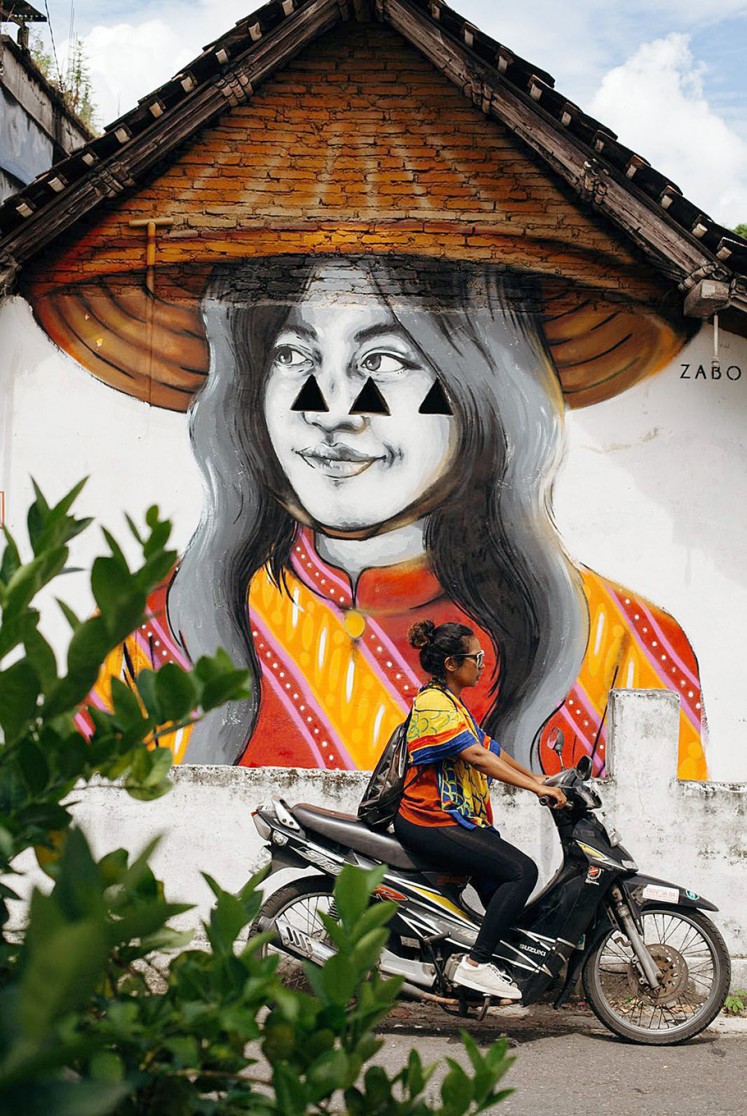 Beautify: A mural by Zabou turns a wall of a house in Yogyakarta into an eye-catching painting.