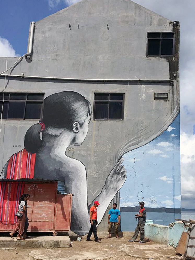 Go local: A mural in Kupang, East Nusa Tenggara, by French street artist Zabou depicts a woman with local traditional cloth draped over her shoulder.