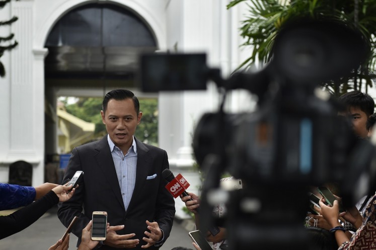 All set: Democratic Party executive Agus Harimurti Yudhoyono talks to journalists after his meeting with President Joko 