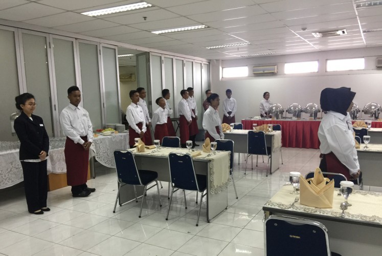 Samantha (left) poses alongside other participants of ART Hospitality during a practice event on Jan. 13 in North Jakarta.