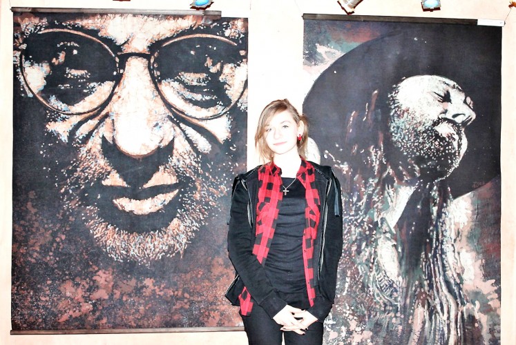 Up close: A woman stands in front of batik portraits of jazz musicians created by Polish teenagers from the Przasnysz Art Center in Przasnysz, a small town in north-eastern Poland. The portraits were made in 2015.