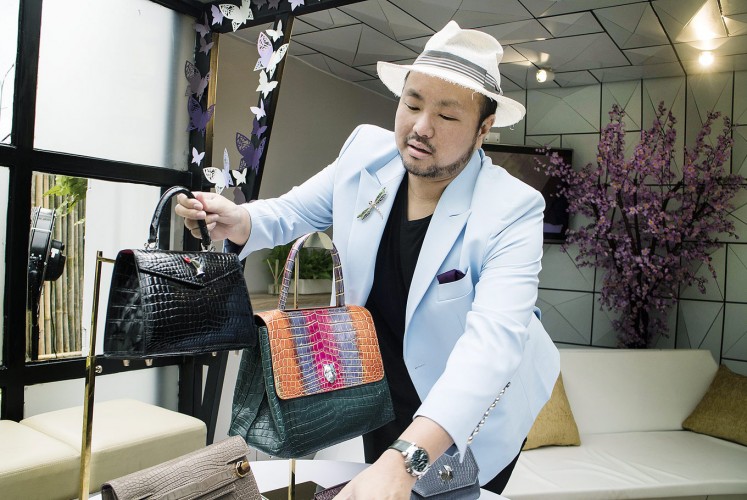 In style: Singaporean handbag designer Ethan Ko displays his designs.