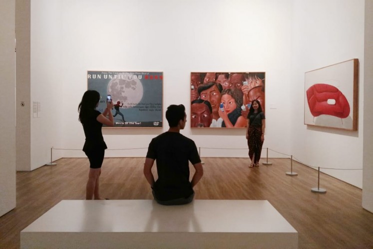 Visitors enjoying artworks in the museum