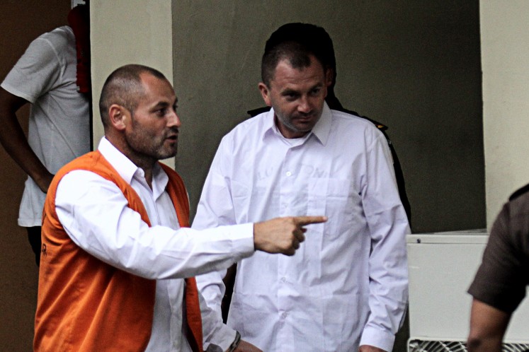 Suspected: Two Romanian citizens, Ion Labanji, 40, and Iurie Vabrie, 37, proceed to the hearing room at the Denpasar District Court on March 22.  