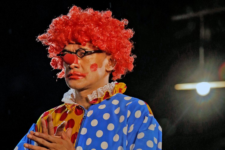 Tragic Comedy: Mukri poses as his alter ego, the clown.