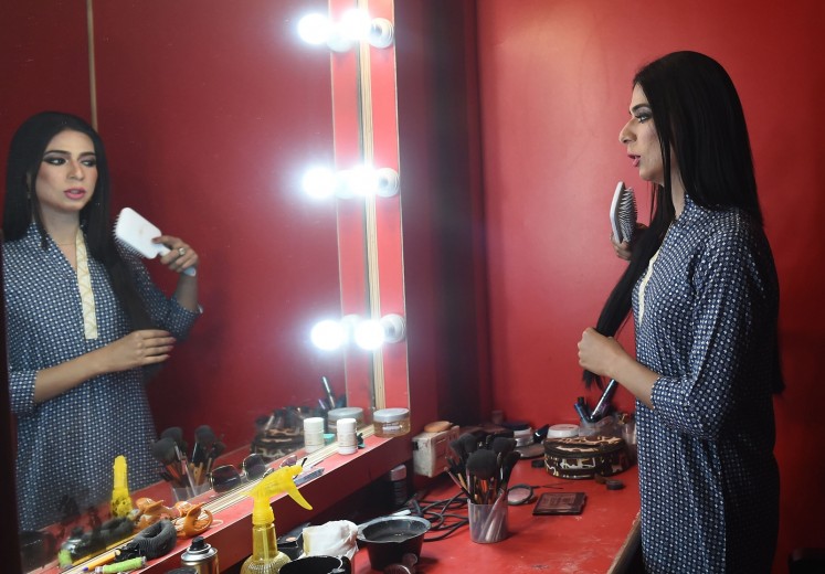 In this photograph taken on March 27, 2018, Pakistan's first transgender news anchor Marvia Malik, 21, prepares before going live to read the news for the private channel Kohenoor in Lahore. 